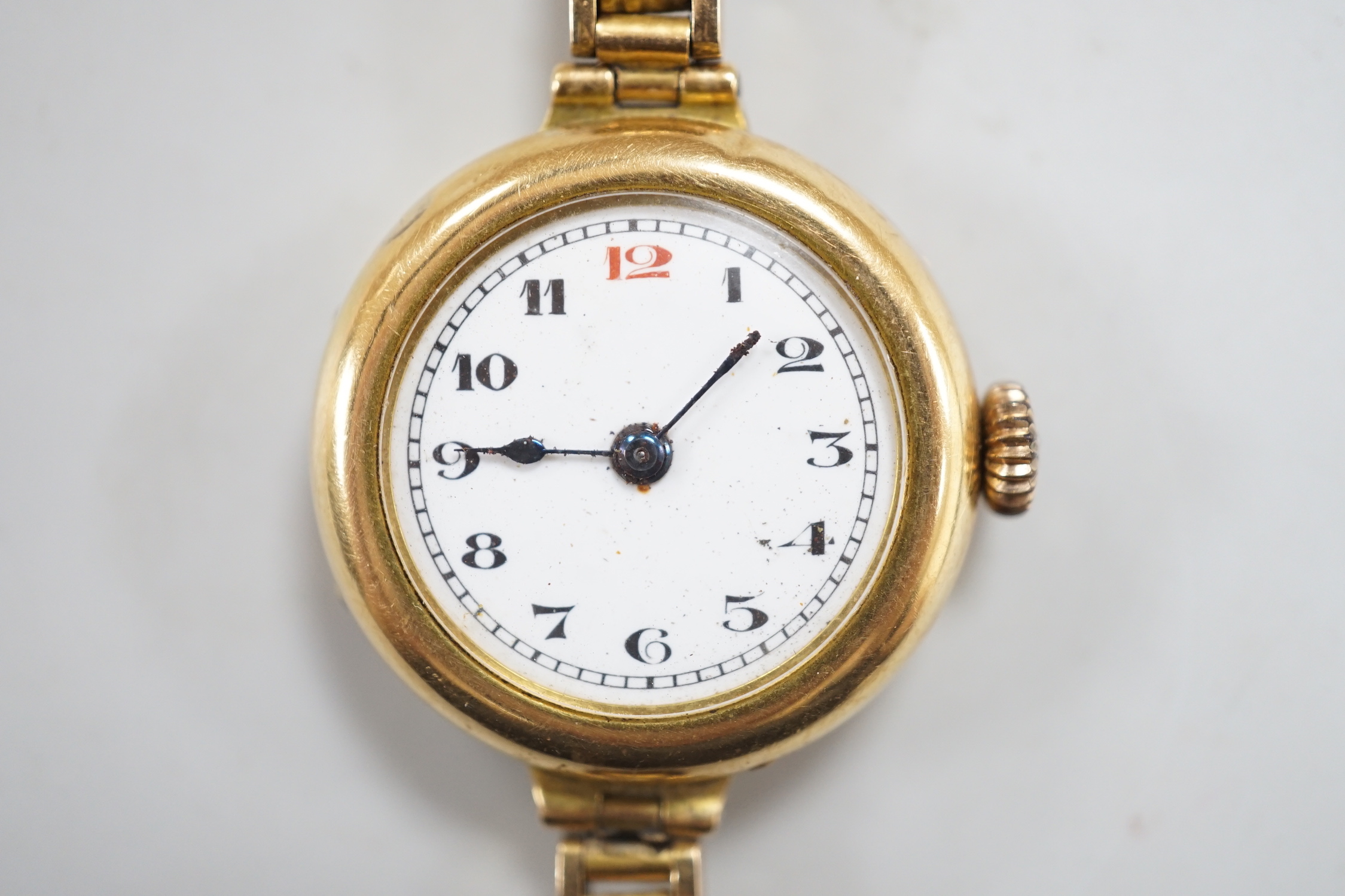 An early 20th century 18ct gold manual wind wrist watch, on an 18ct flexible bracelet, case diameter 25mm, gross weight 25.9 grams.